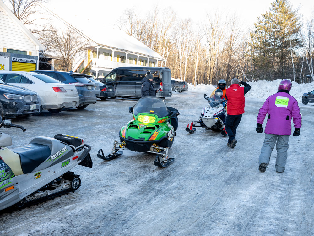 People preparing for a snowmobile ride at the 2023 NHSA Ride-In for Camp Sno-Mo