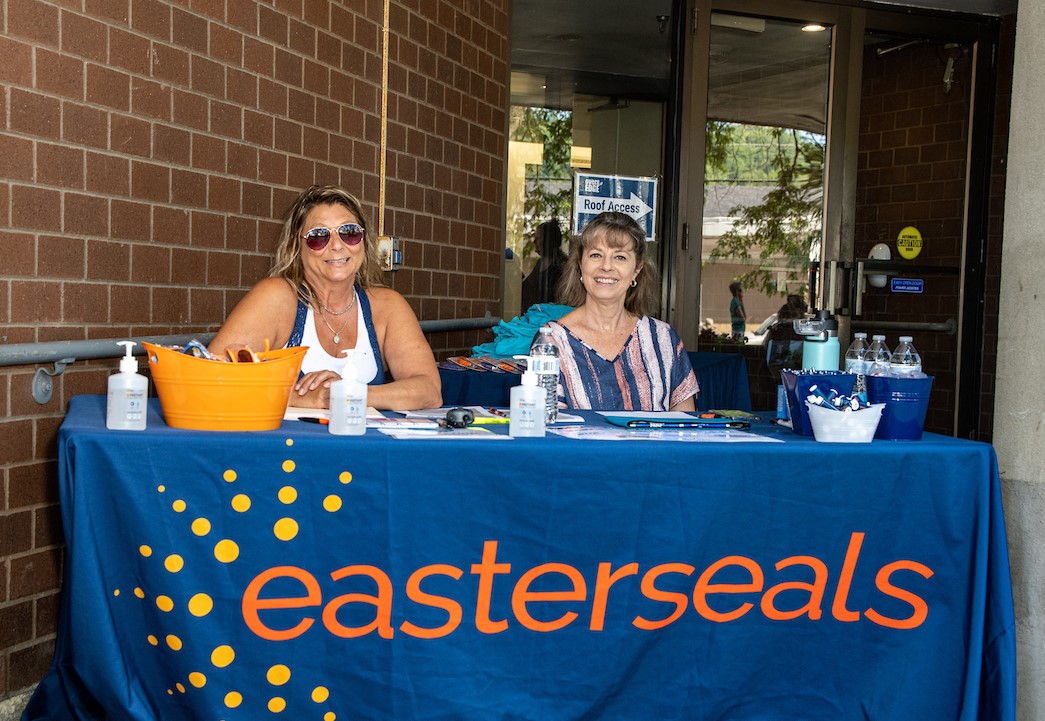 Easterseals VT volunteers sitting at a table for the Over The Edge event.