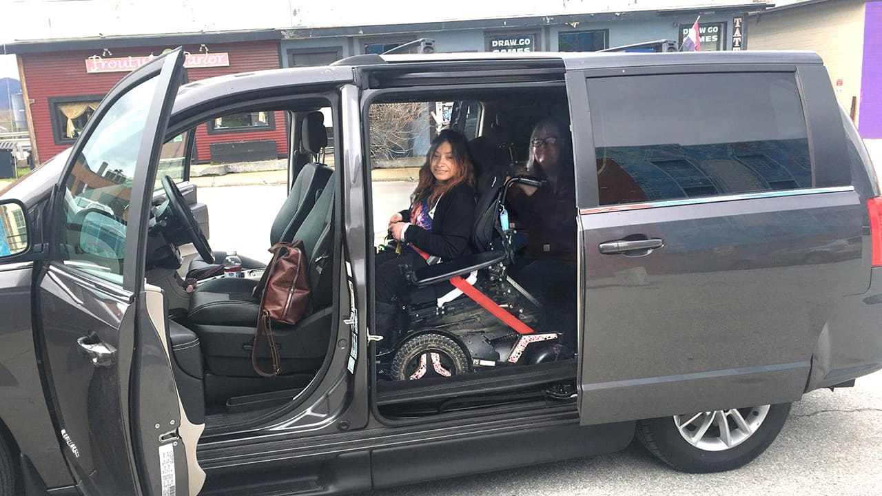Angel sitting in backseat of a van