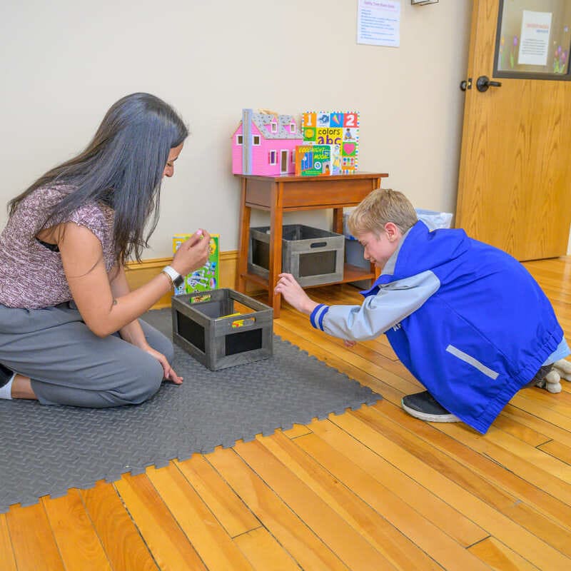 Easterseals VT staff playing with child in VT office