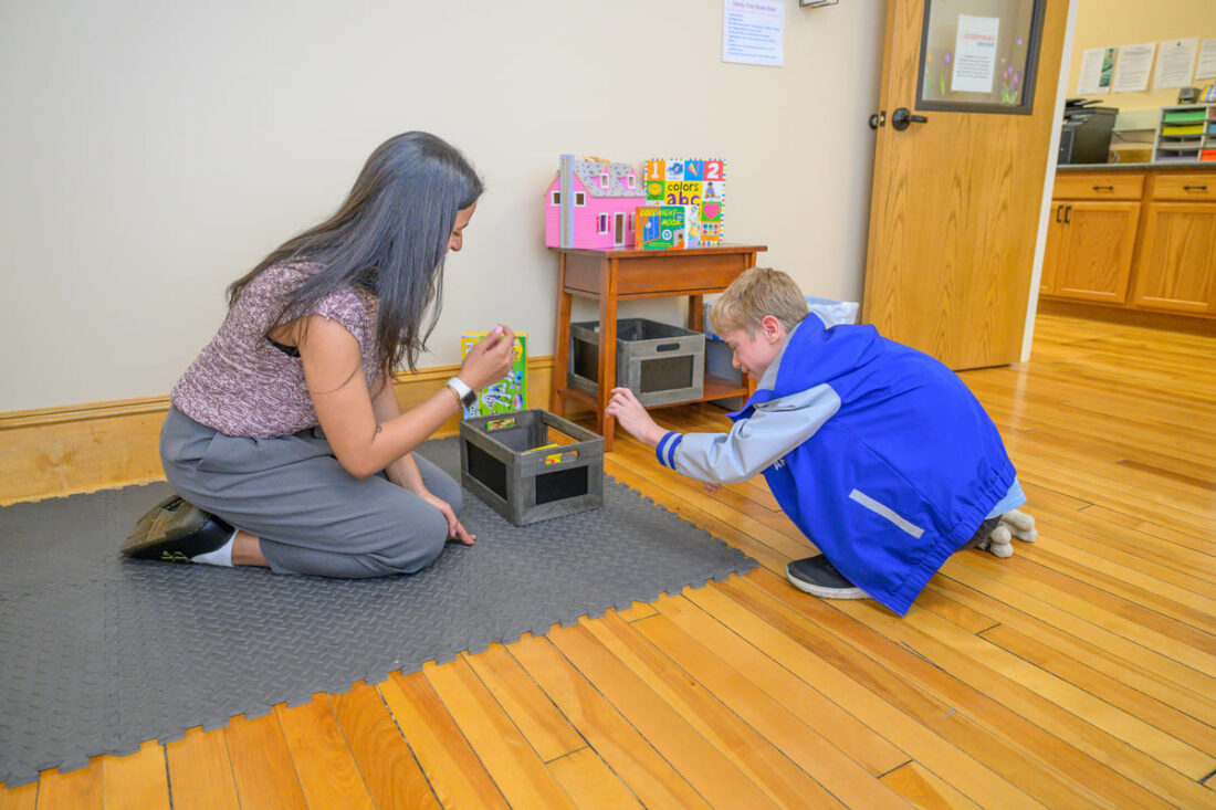 Easterseals VT staff playing with child in VT office