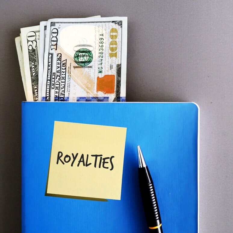 Blue folder with filled with money. Sticky note that reads, "royalties."