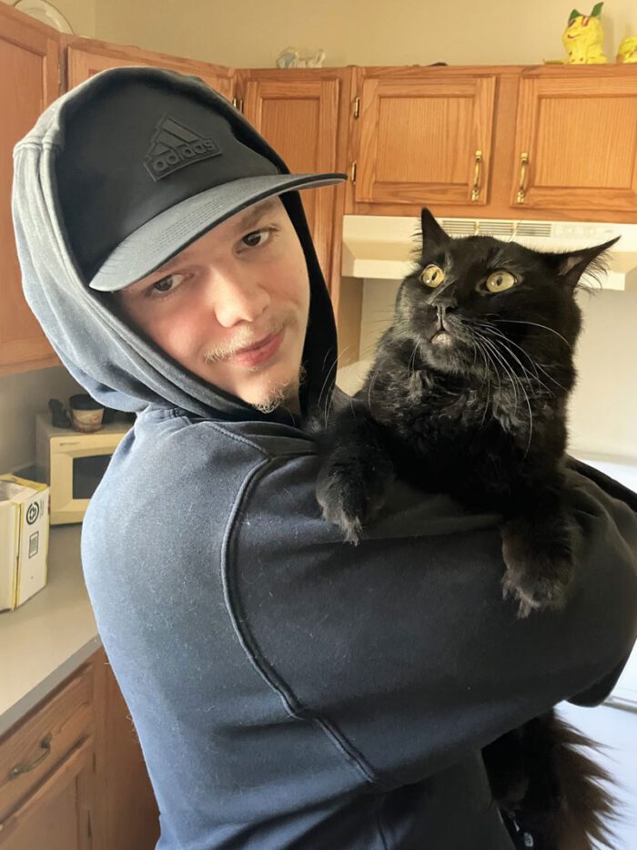 Dakota holding his cat named Thunder.