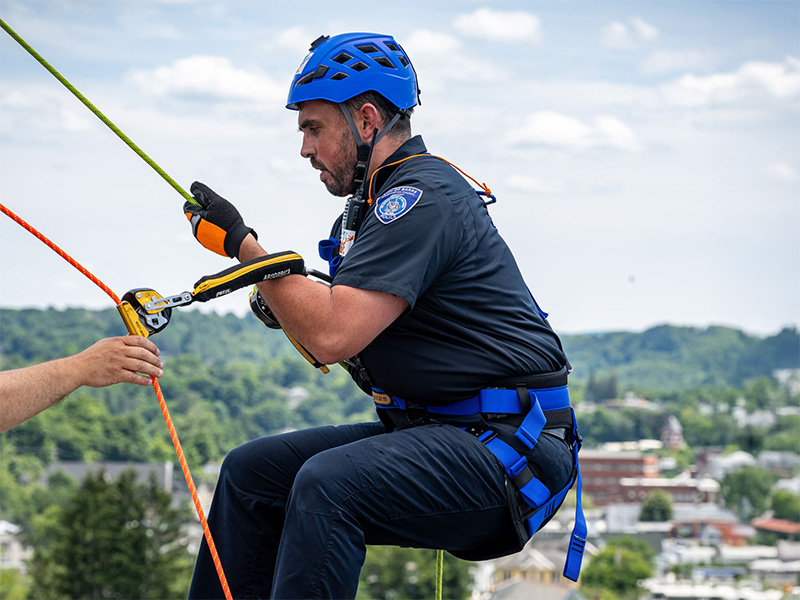 BARRE CITY’S OFFICER MCGOWAN GOES OVER THE EDGE - Barre City Officer James McGowan takes his first step in his descent of the North Barre Manor at Easterseals VT’s Over the Edge event on Saturday, July 20. Funds raised from the event support a wide array of services for at-risk children and families.