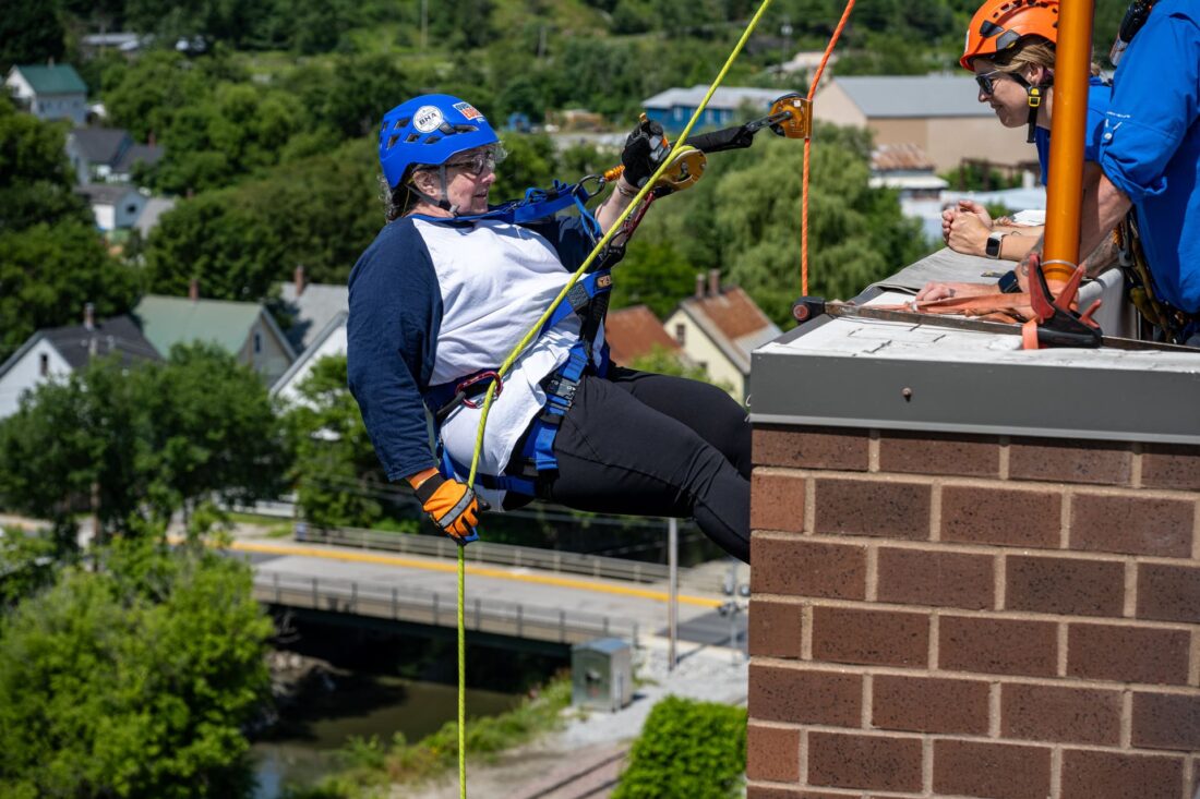 Person repelling at 2025 Easterseals VT Over the Edge event
