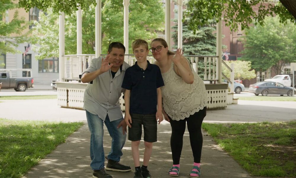 Keegan with his mom and dad in the park