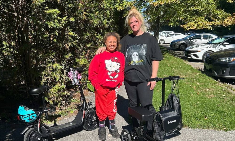 Destiny and her mother, Teri standing next to their electric scooters